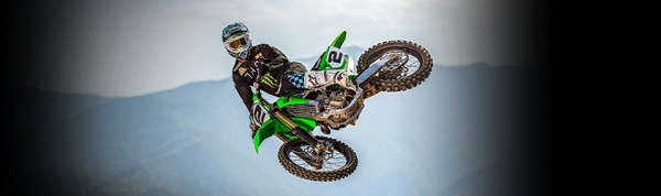 Motorcycle rider on KLX650 on a dirt trail
