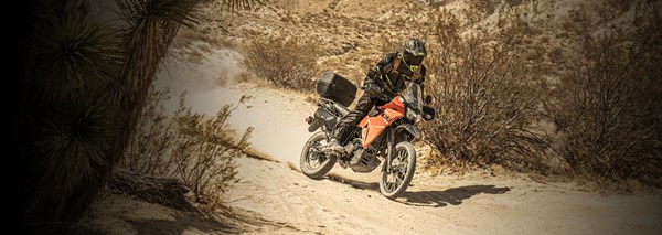 Motorcycle rider on KLX650 on a dirt trail