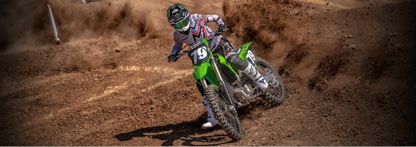 Motorcycle rider on KLX650 on a dirt trail