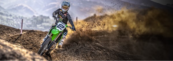 Motorcycle rider on KLX650 on a dirt trail