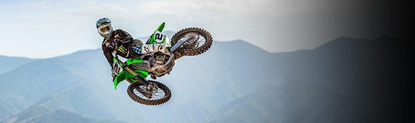Motorcycle rider on KLX650 on a dirt trail