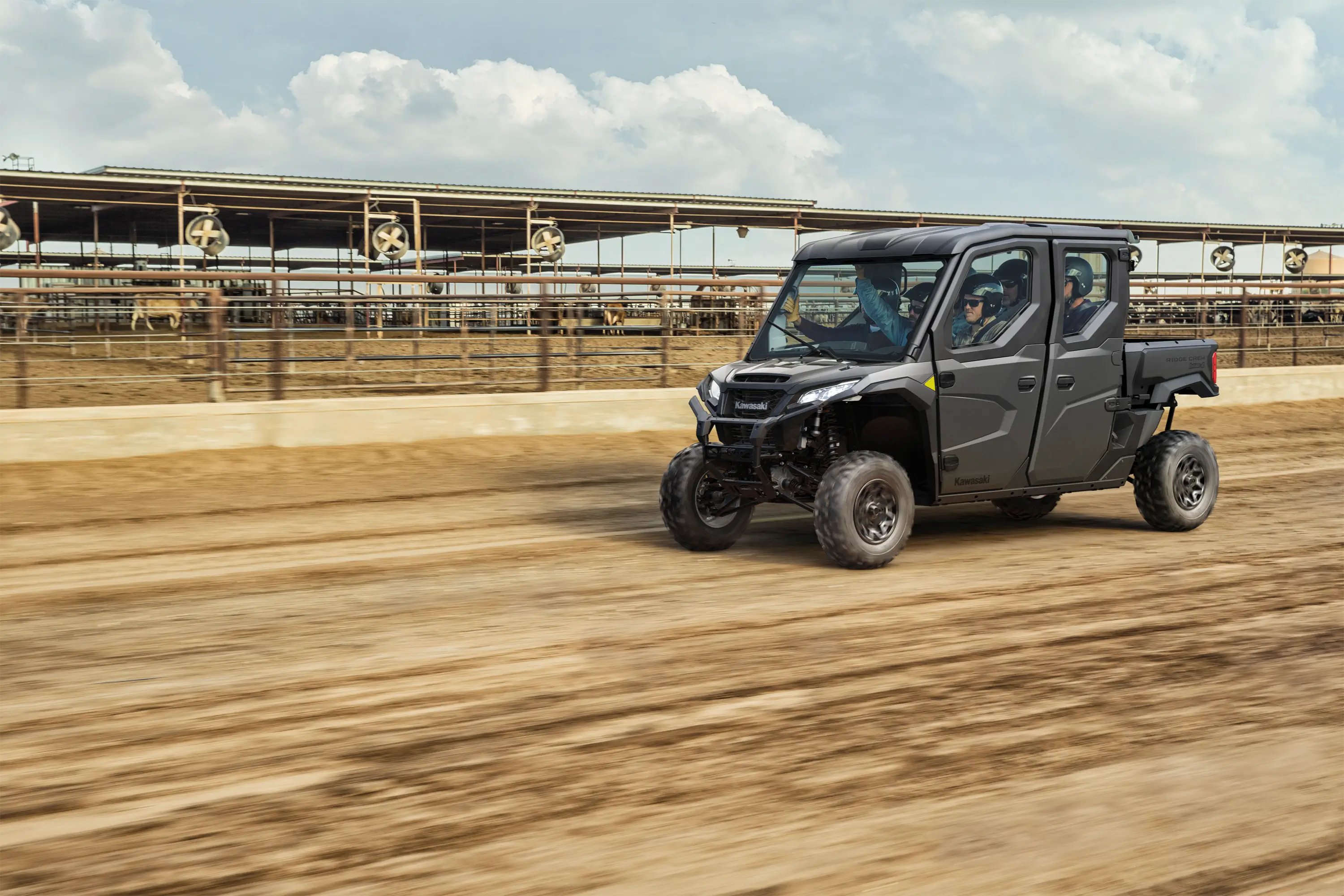 Three-quarter front angle of a person driving a side x side off-road.