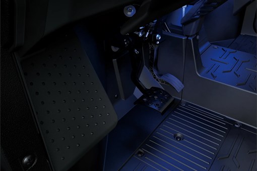 Side x side interior footwell in a blue glow. opens in a new window