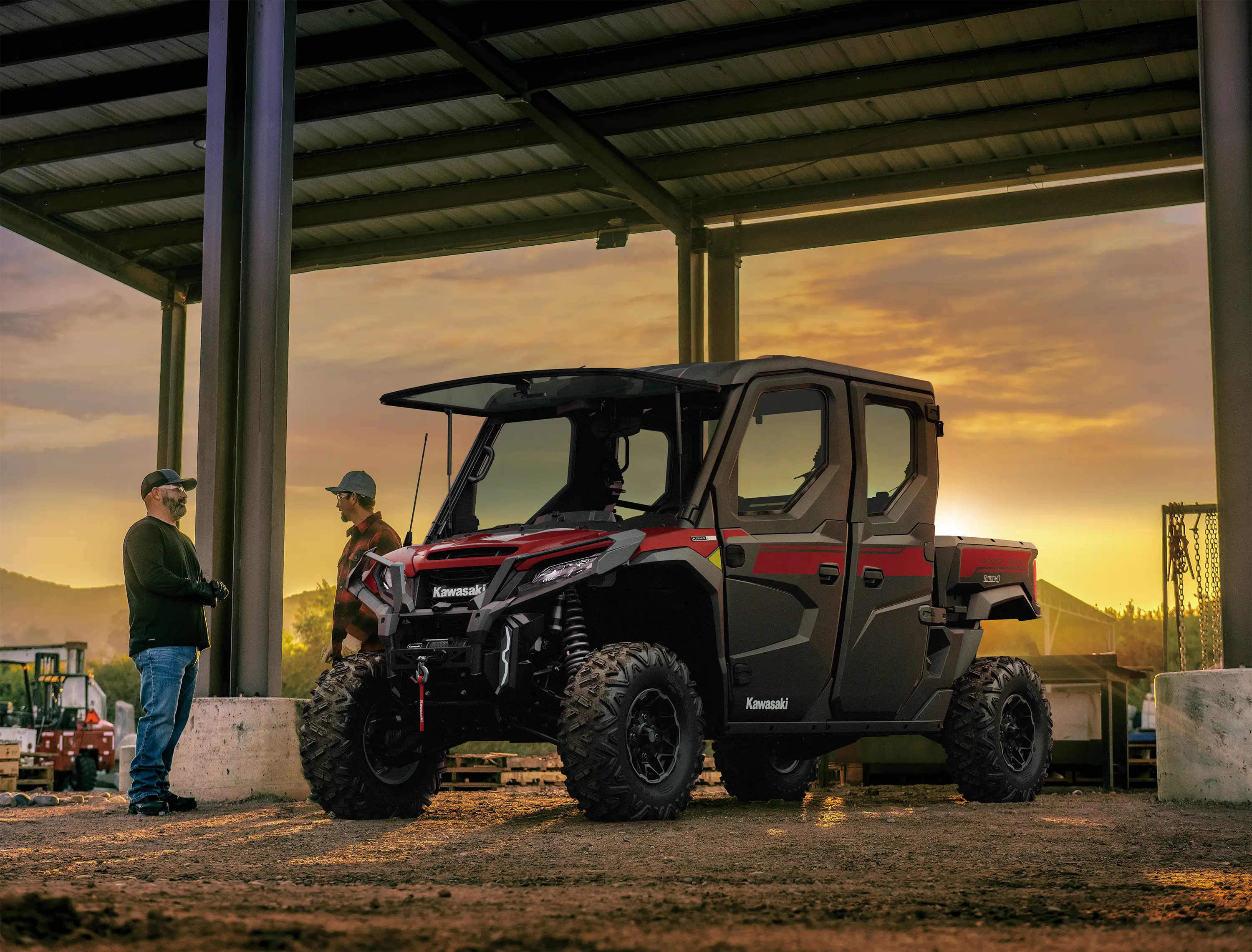 Side x side parked on a ranch at sunset.