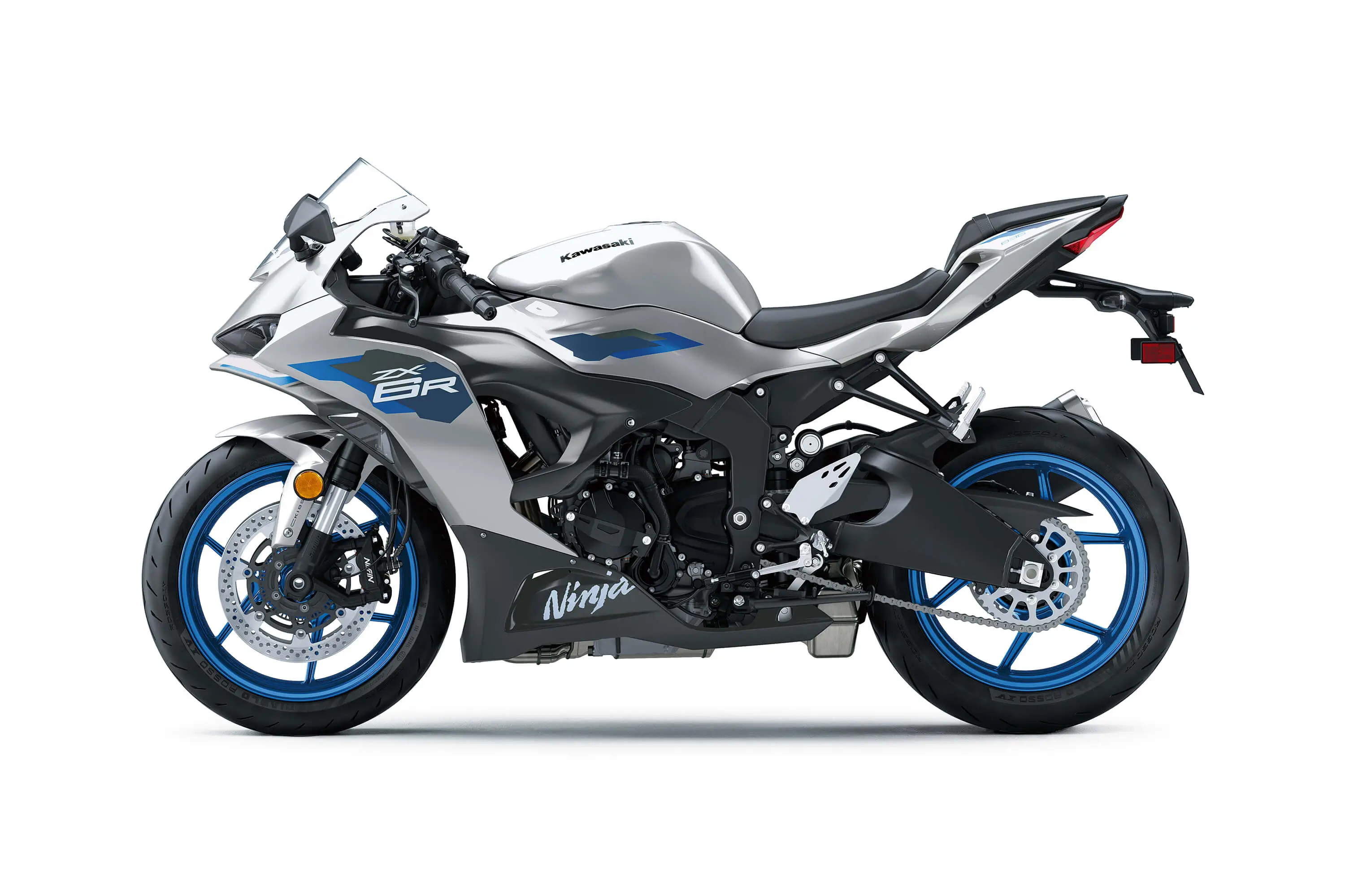 Profile angle of a silver motorcycle staged in a white studio background.