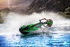 Profile angle of person riding a personal watercraft through a turn on water.