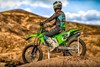 Profile angle of a person sitting on a motorcycle off-road.