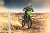 Three-quarter front angle of a person riding a motorcycle off-road.