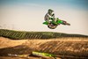 Front angle of person getting air on motorcycle on a track.