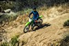 Overhead angle of a person riding a motorcycle off-road.