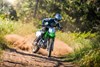 Front angle of a person riding a motorcycle off-road.
