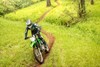 Front three-quarter angle of a person riding a motorcycle off-road.