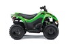 Profile angle of a green ATV with a white studio background.