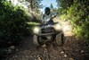 Front angle of a person riding an ATV off-road.