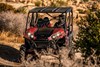 Front angle of a person driving a side x side off-road.