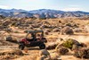 Profile angle of a person driving a side x side off-road.