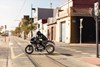 Profile angle of person riding a motorcycle.