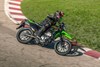 Profile angle of person riding a motorcycle on a racetrack.
