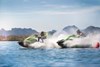 Two people side-by-side on Jet Ski vehicles. 