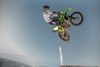 Profile angle of person getting air on motorcycle.