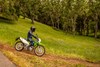Profile angle of a person riding a motorcycle off-road. 