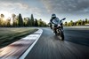 Front angle of person riding a motorcycle on a track.