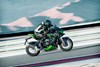 Profile angle of person riding a motorcycle on a track.