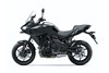 Side angle of a black motorcycle staged in a white studio background.