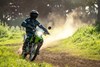 Front angle of person riding a motorcycle on a dirt trail.