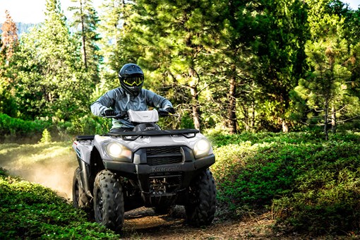 Front angle of a person riding an ATV off-road. opens in a new window