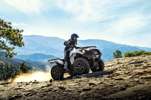 Side angle of a person riding an ATV off-road. opens in a new window