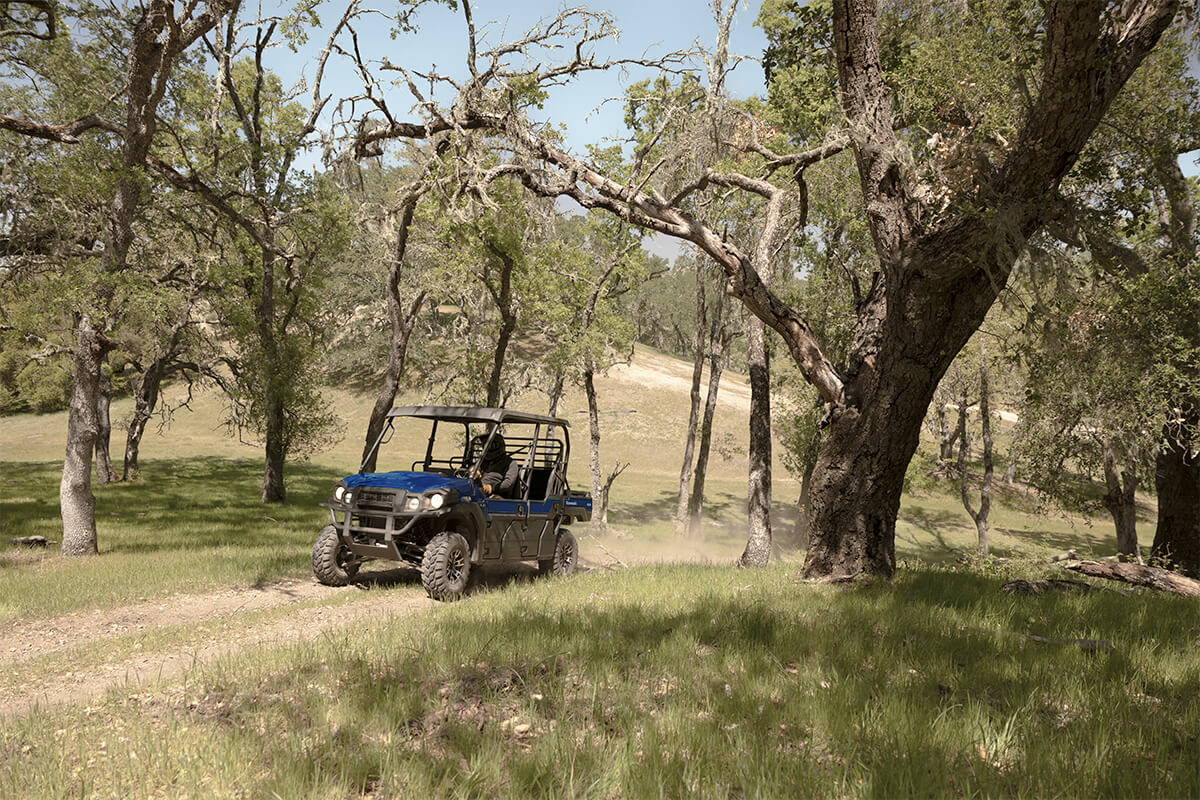 Front three-quarter angle of a person driving a side x side off-road.