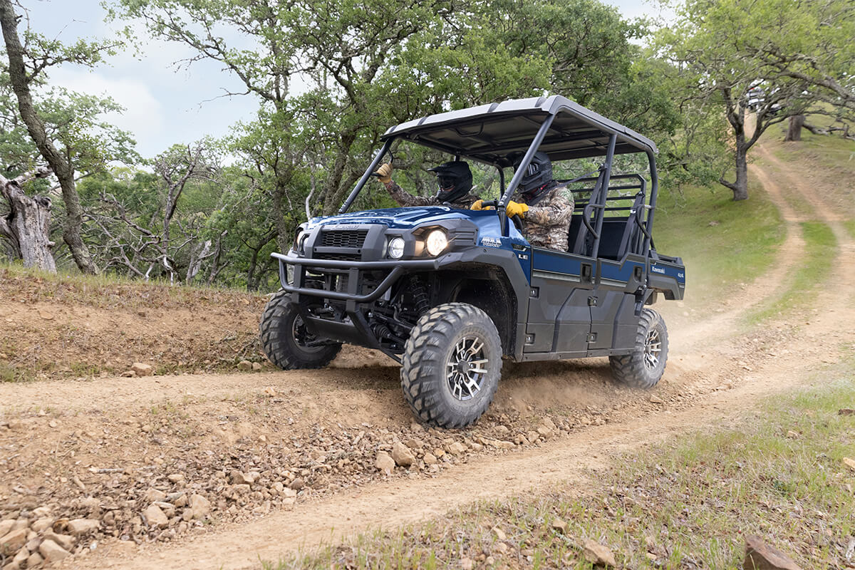 Three-quarter front angle of a person driving a side x side off-road.