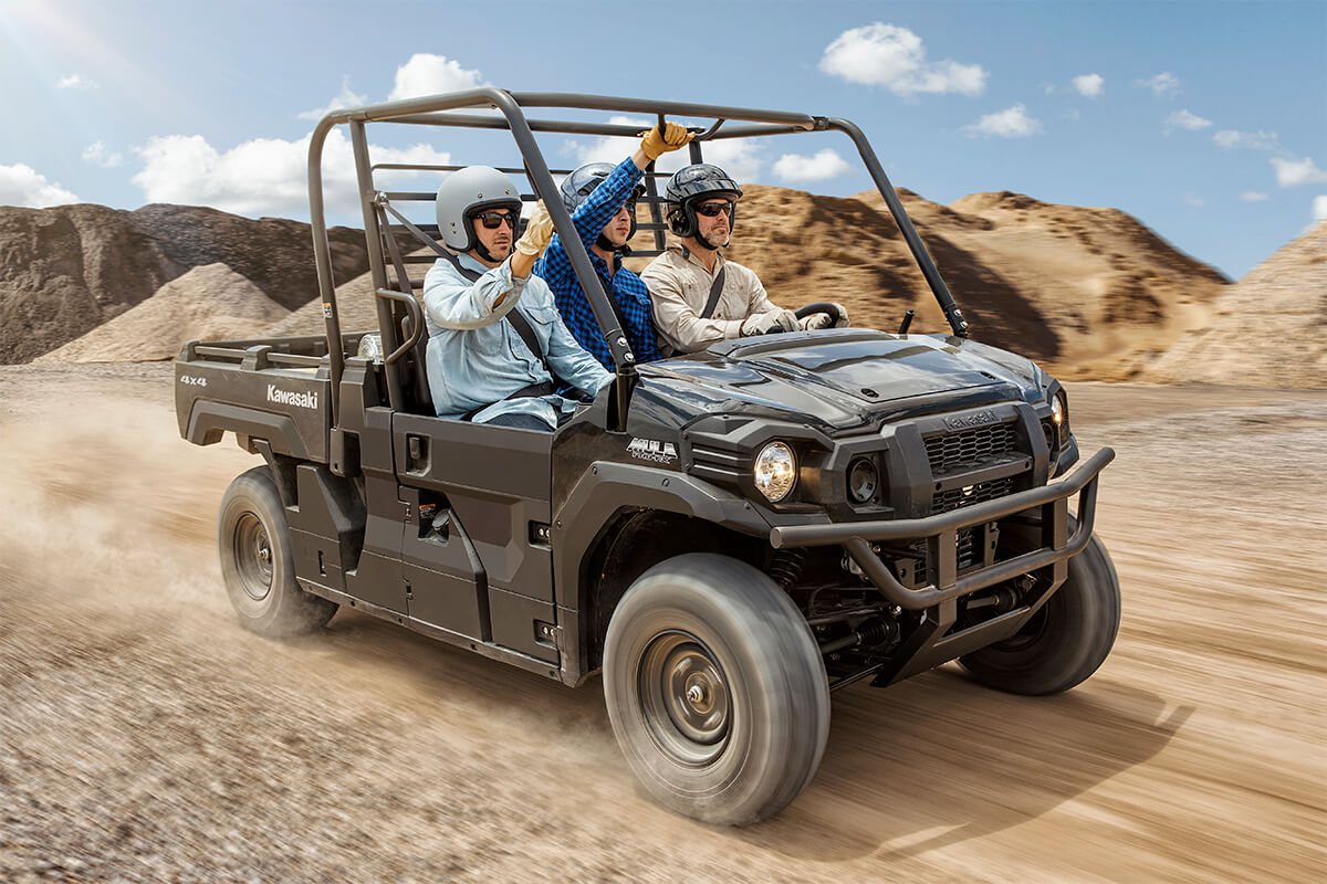 Three-quarter front angle of a person driving a side x side off-road.