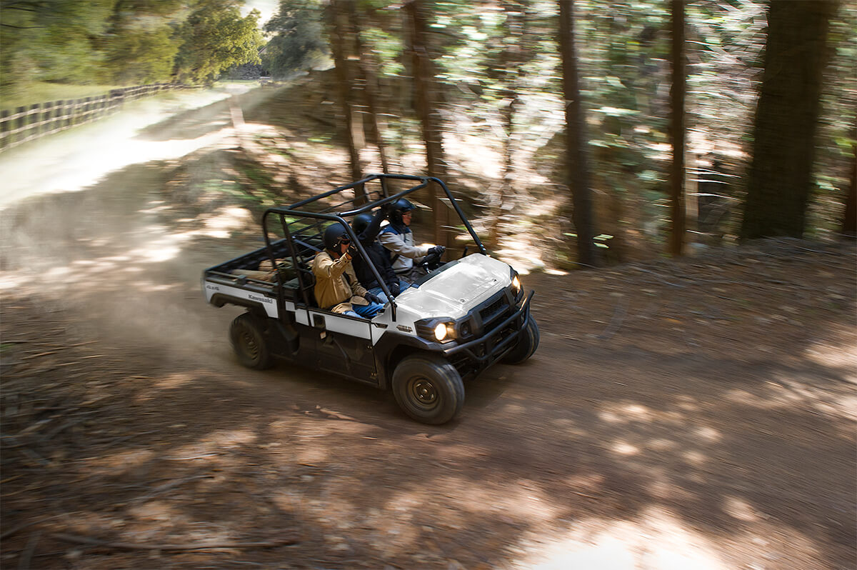 Overhead three-quarter front angle of a person driving a side x side off-road.