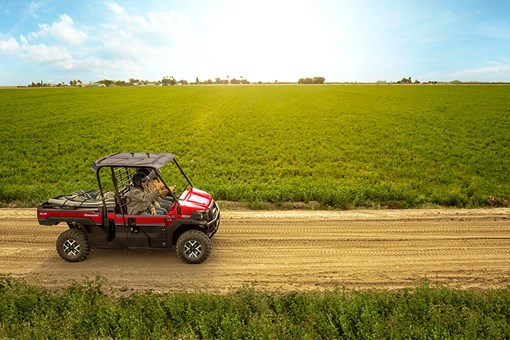 Side angle of a person driving a side x side off-road. opens in a new window
