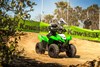 Three-quarter front angle of a child making a sharp turn on a youth ATV off-road.