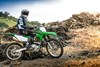 Side angle of a person riding a motorcycle off-road.