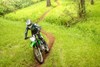 Front three-quarter angle of a person riding a motorcycle off-road.