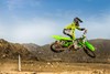 Side angle of a person catching air on a motorcycle off-road.