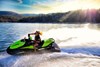 Side angle of a person on a personal watercraft on the water.