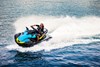 Overhead angle of a person on a personal watercraft on the water.