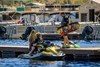 Side angle of a personal watercraft on the water.