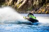 Front angle of a person on a personal watercraft on the water.
