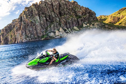 Profile angle of a person on a personal watercraft on the water. opens in a new window