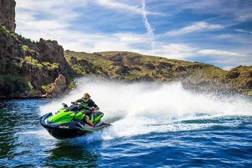 Front three-quarter angle of a person on a personal watercraft on the water. opens in a new window