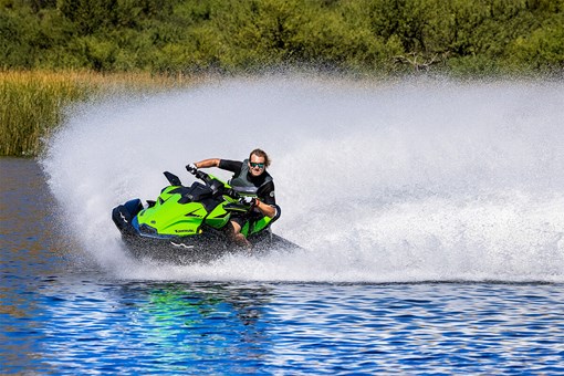 Three-quarter front angle of a person on a personal watercraft on the water. opens in a new window