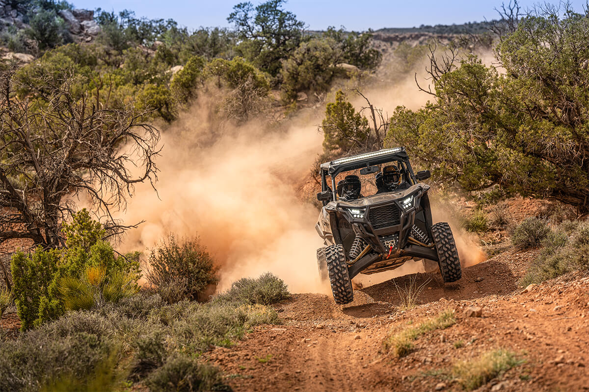 Front angle of a person coming out of a turn in a side x side off-road.