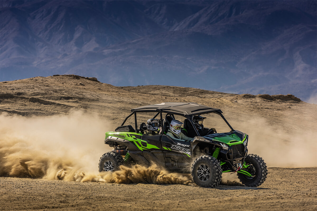 Side angle of a person driving a side x side off-road.