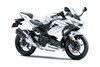 Three-quarter front angle of a white motorcycle staged in a white studio background.